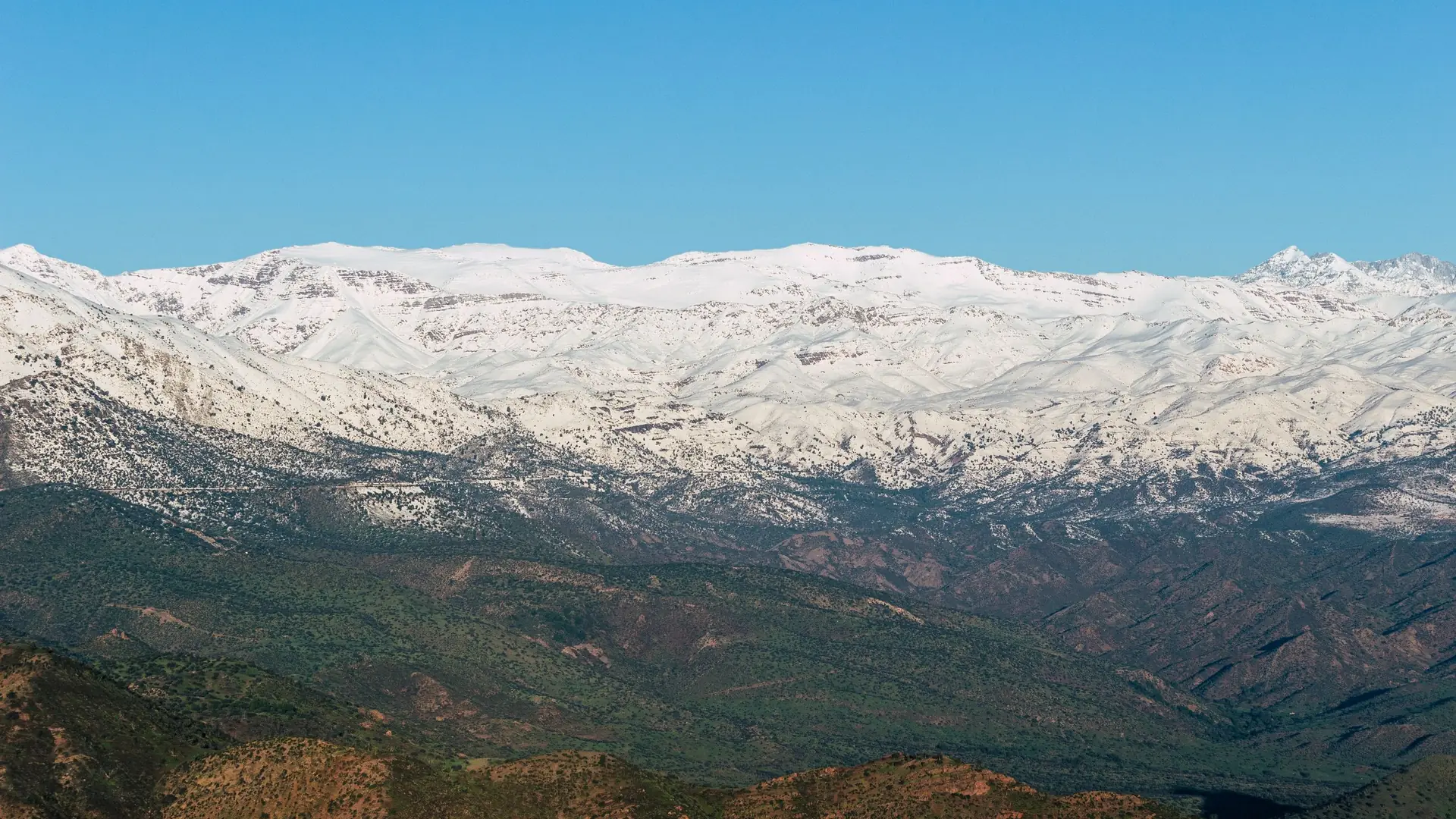 The snow-covered High Atlas range seen from the foothills