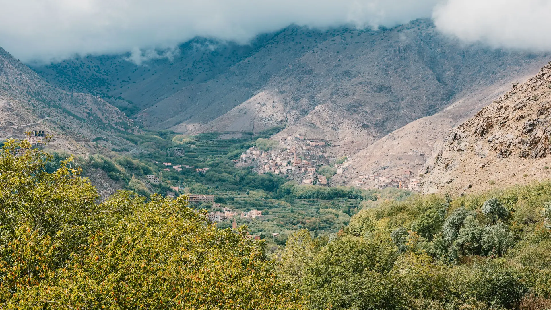 The green Imlil valley below the Toubkal massif under passing clouds